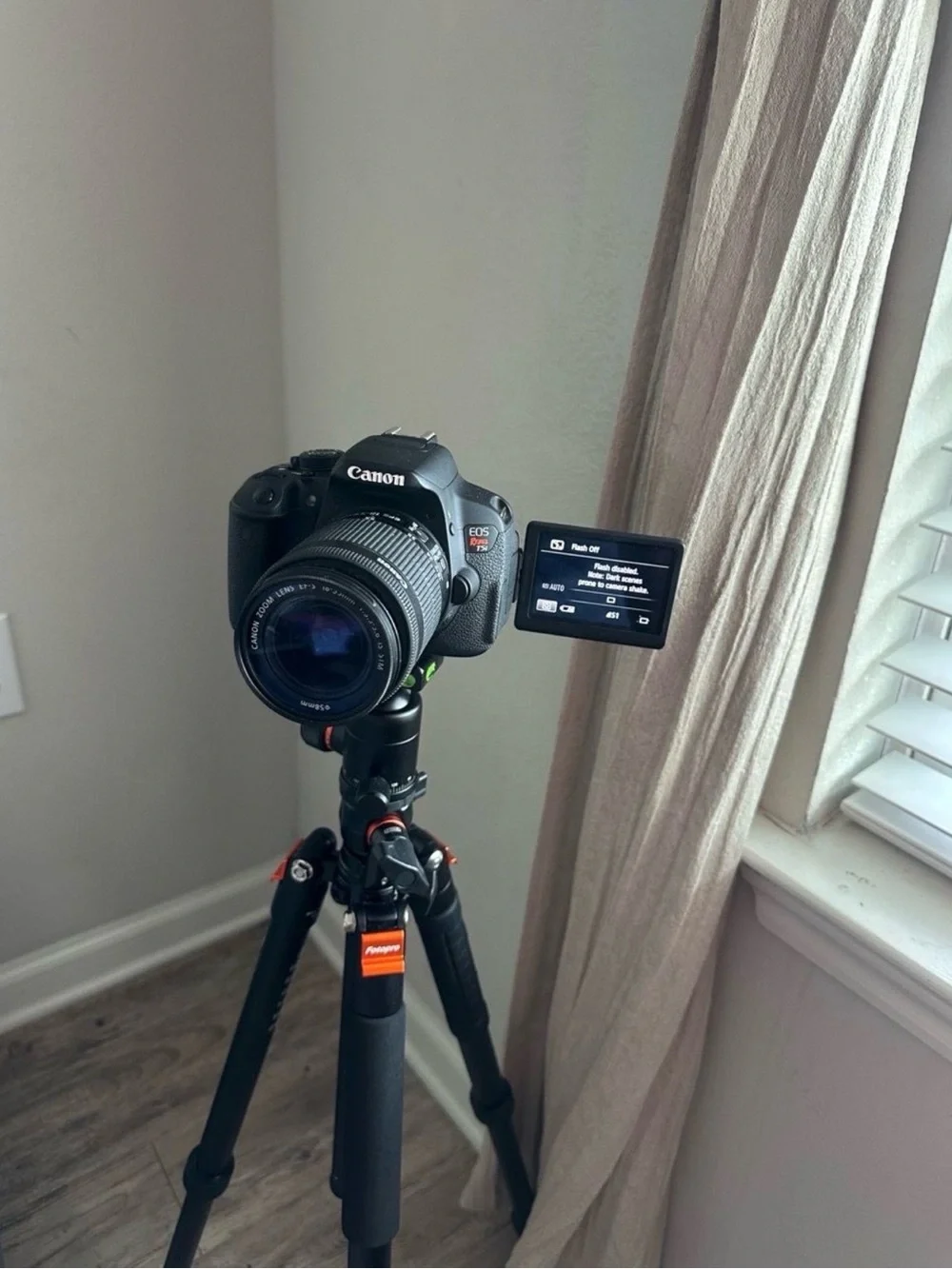 Canon Black DSLR Camera with Rotating LCD and Black Tripod